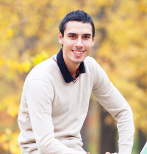 programmer-with-notebook-sitting-in-autumn-park-HPAWSZN.jpg